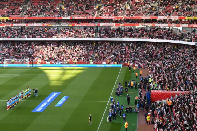 The teams take to the field ahead of kick off.