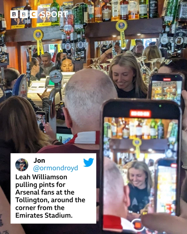 Leah Williamson pours drinks for fans ahead of Wolfsburg UWCL game.