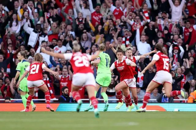 Arsenal celebrate their equaliser.