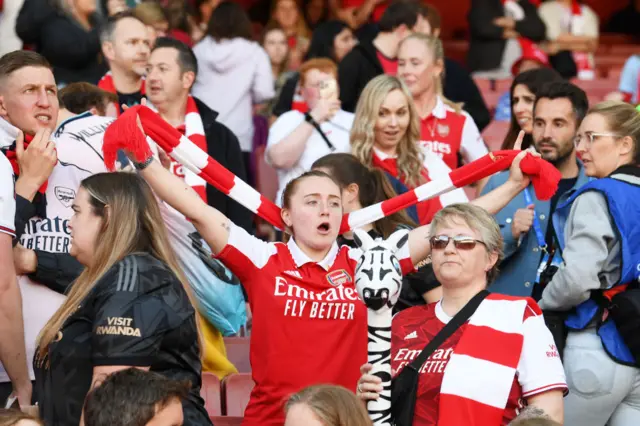 Fans cheer as the players come out to warm up.