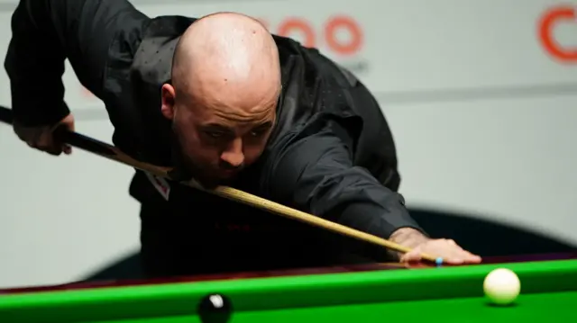 Luca Brecel plays a shot