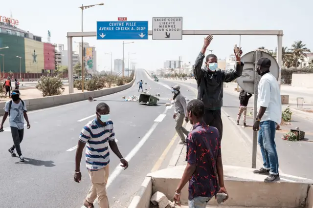 Protesters gather at a road block on a highway in Dakar on March 30, 2023.