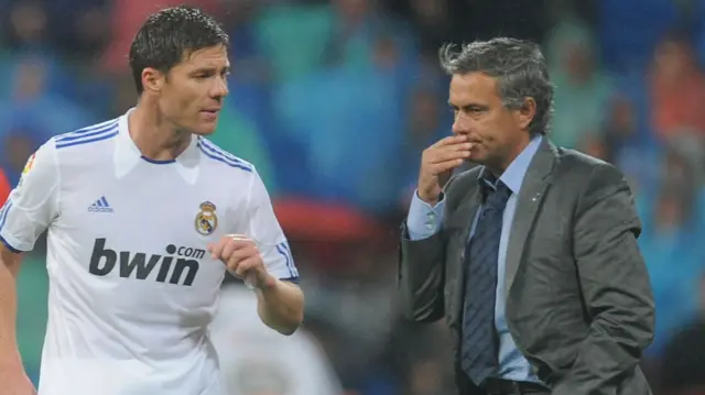 Xabi Alonso speaking to Jose Mourinho