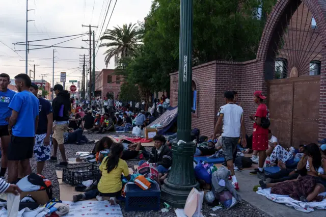 Migrants wait in a border town