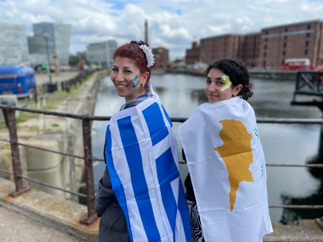 Women draped in Greek and Cypriot flags