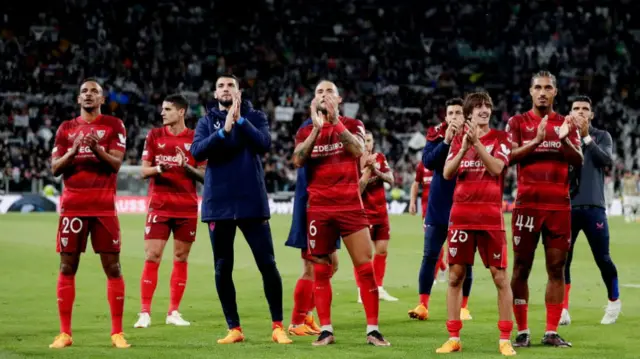 Sevilla players applaud their supporters