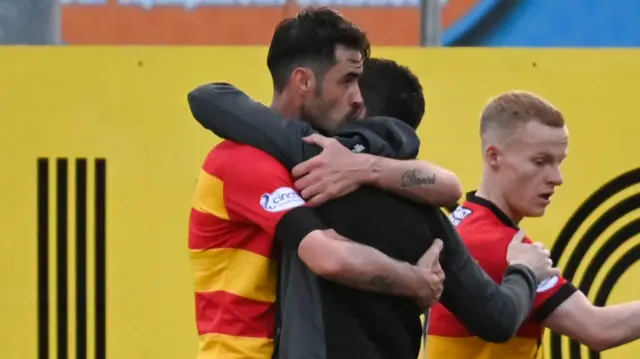 Brian Graham embraces his manager Kris Doolan after a game-winning performance