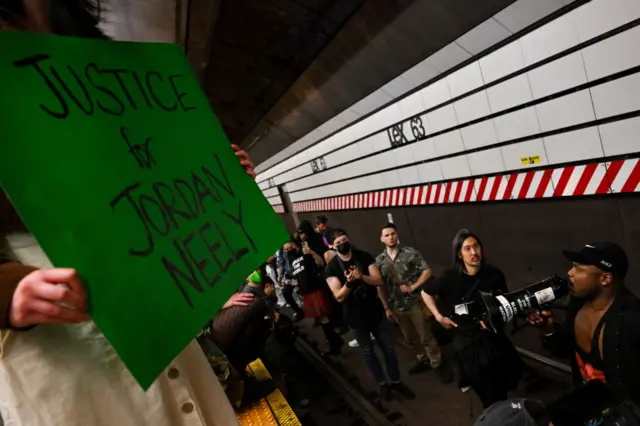 Protesters stand on the train tracks at the Lexington Ave/63rd Street subway station during a "Justice for Jordan Neely" protest