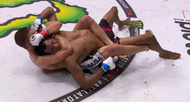 Mansour Barnaoui is being choked by Brent Primus in a submission