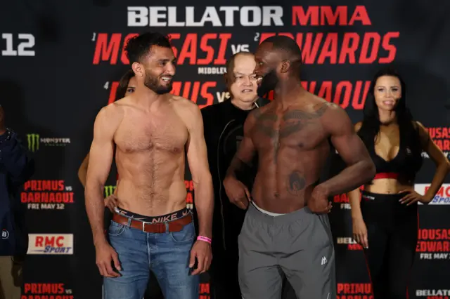 Gegard Mousasi and Fabian Edwards grin at each other at the weigh-ins