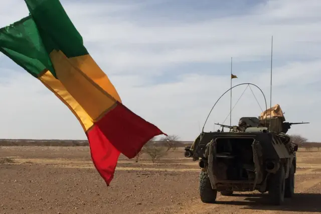 Malian flag and military vehicle