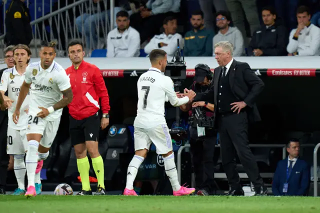 Carlo Ancelotti greets Eden Hazard after substituting him.