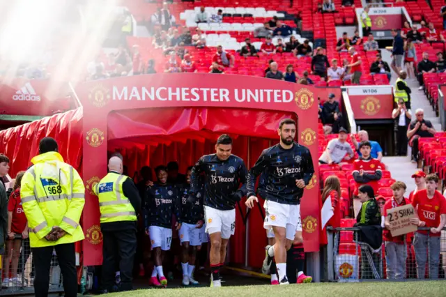 Man Utd players take to the field to warm up.