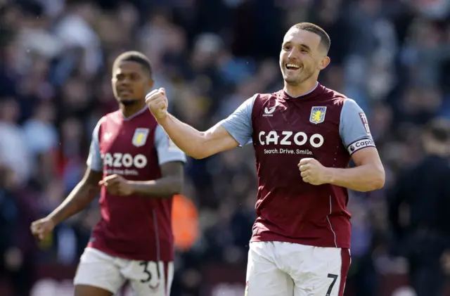 Aston Villa's John McGinn celebrates after beating Tottenham