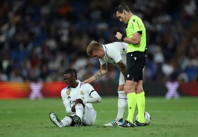 Eduardo Camavinga sits on the floor after twisting his knee.