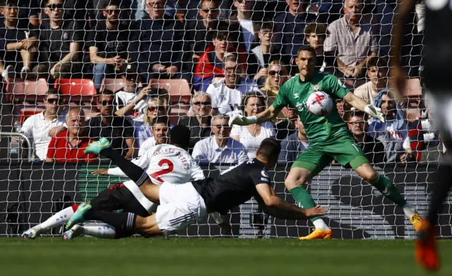 Mitrovic dives in to score Fulham's second goal of the game.