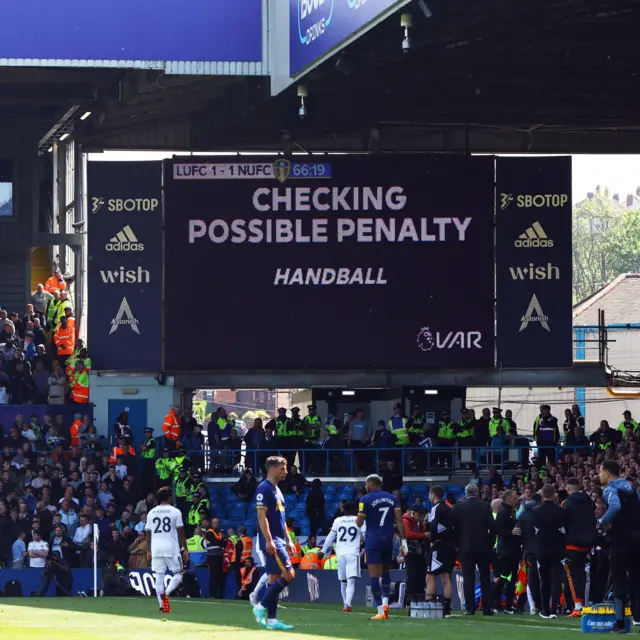 The crowd wait as VAR check a penalty against Leeds.