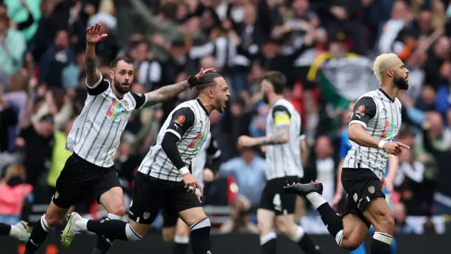 Notts County celebrate John Bostock's earlier equaliser against Chesterfield