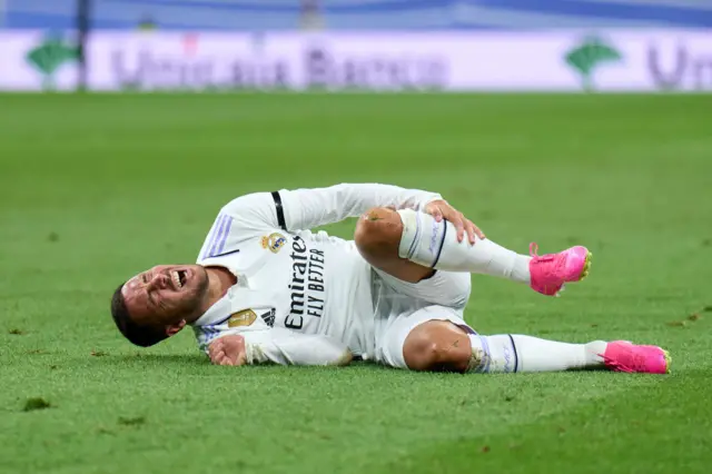 Eden Hazard lies injured on the ground after being fouled.