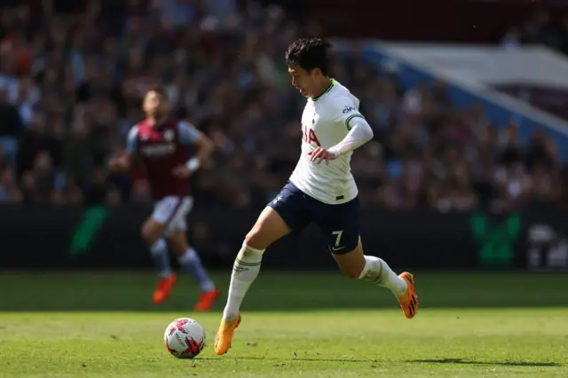 Tottenham Hotspur striker Son Heung-Min runs with the ball against Aston Villa