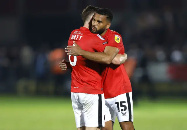 Salford's Elliot Watt hugs team-mate Adrian Mariappa after their win over Stockport