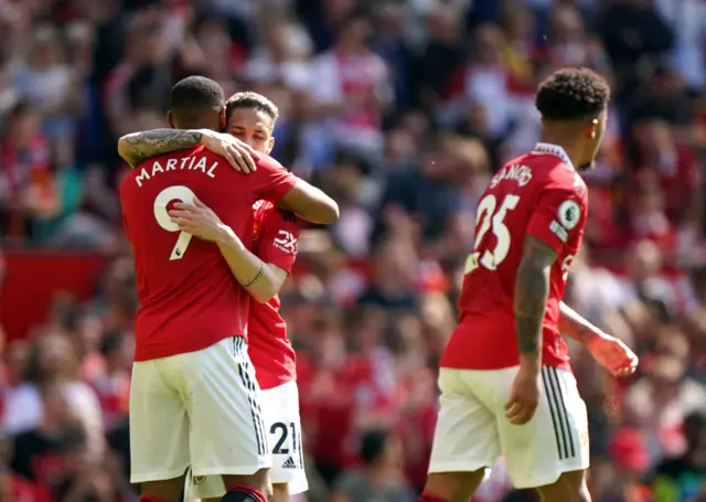 Antony and Martial celebrate after combining for the opening goal.