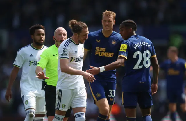 Luke Ayling and Joe Willock have a disagreement over a decision.