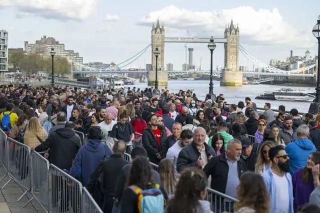 Turkish voters are waiting in line outside of the polling station in London