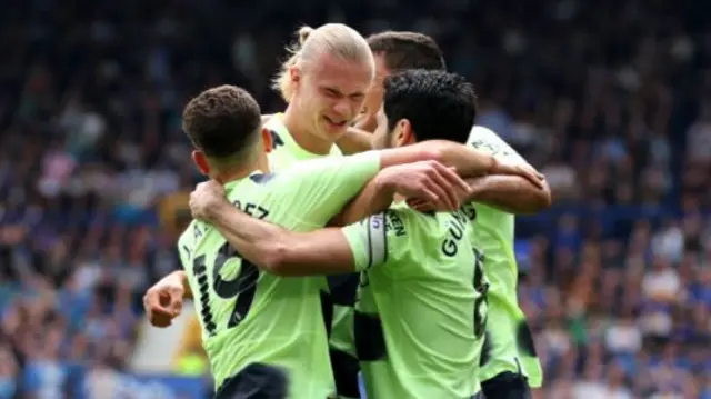 Erling Haaland is congratuled by his Manchester City team-mates after scoring against Everton