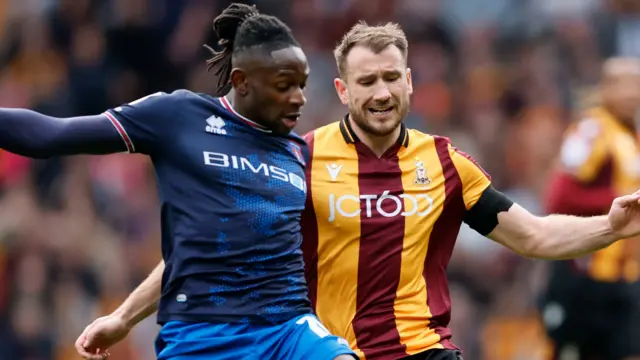 Carlisle and Bradford players challenge for the ball