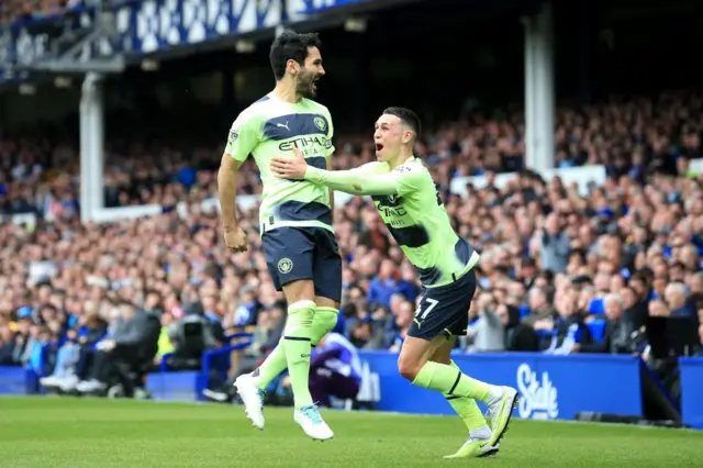 Ilkay Gundogan celebrates scoring a free-kick against Everton