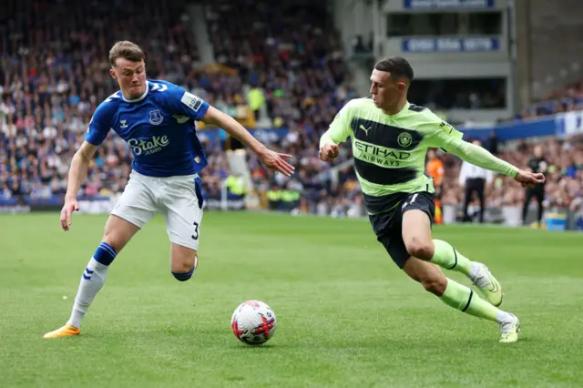 Phil Foden of Manchester City runs at Nathan Patterson of Everton