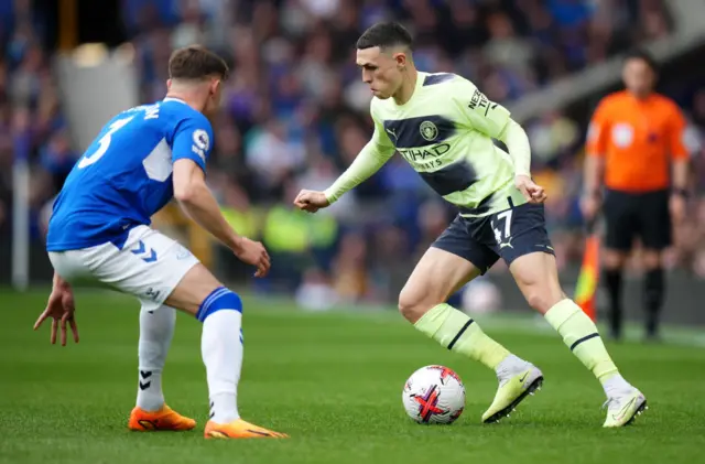 Manchester City's Phil Foden runs at Everton's Nathan Patterson