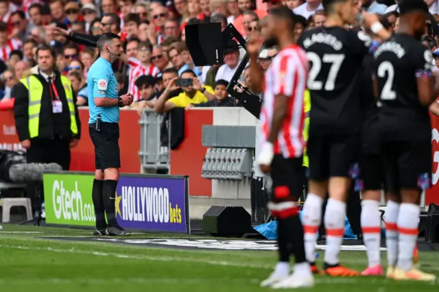 Referee Michael Oliver checks the VAR Screen