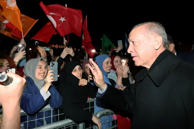 President Erdogan greets his supporters as he leaves his residence in Istanbul