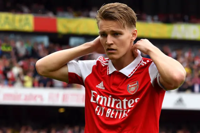 Martin Odegaard adjusts his collar during Arsenal's game with Brighton