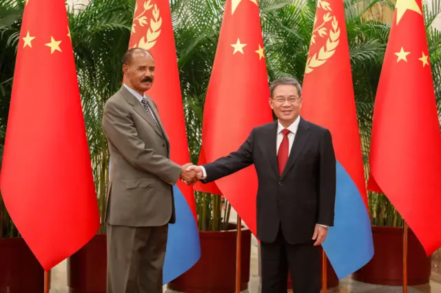 Premier Li Qiang of China (R) and President Isaias Afwerki of Eritrea shake hands as they attend a meeting at the Great Hall of the People on May 15, 2023 in Beijing, China