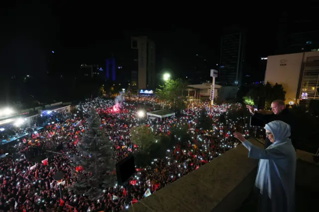 Turkish President Recep Tayyip Erdogan and his wife, Emine Erdogan, greet the crowd from the balcony of AK Party's headquarters.