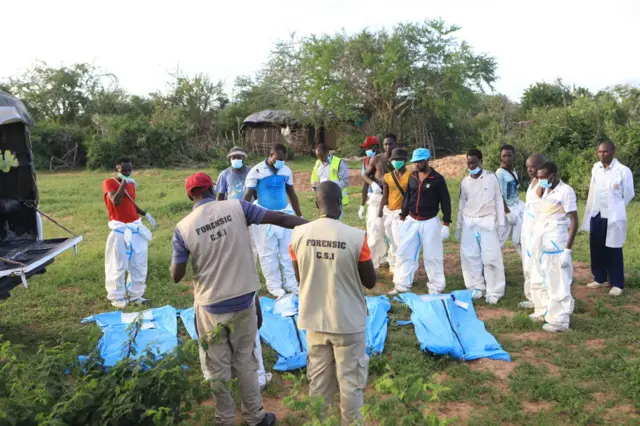 Officials inspect a forested where 145 bodies were found near the Good News International Church in Malindi town of Kilifi, Kenya on May 11, 2023.