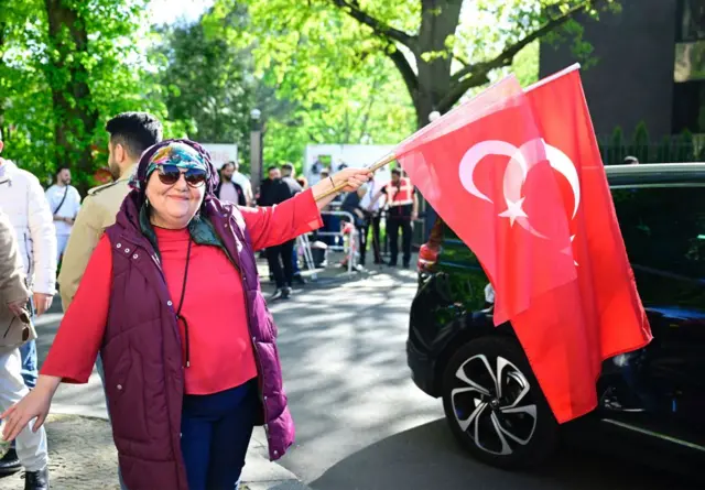 A Turkish voter waves flags as she make her way to the polling station at the Turkish consulate in Berlin earlier this month.