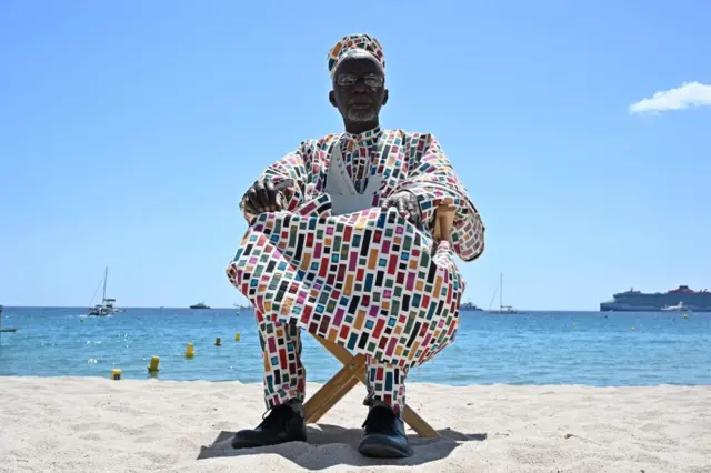 Malian director Souleymane Cisse on a beach in Cannes, France - 16 May 2023