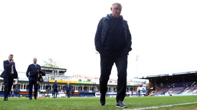 Tony Mowbray walks onto the pitch at Luton