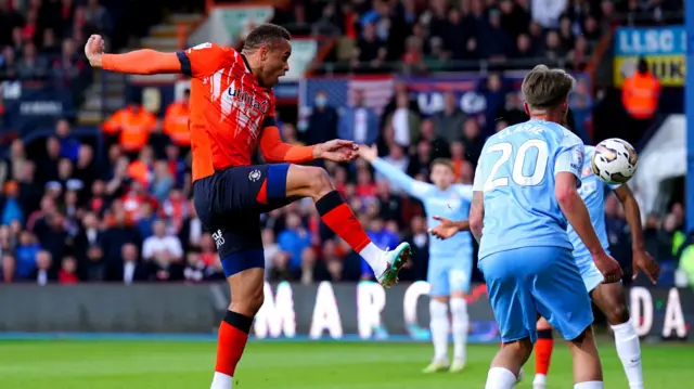 Carlton Morris shoots for Luton