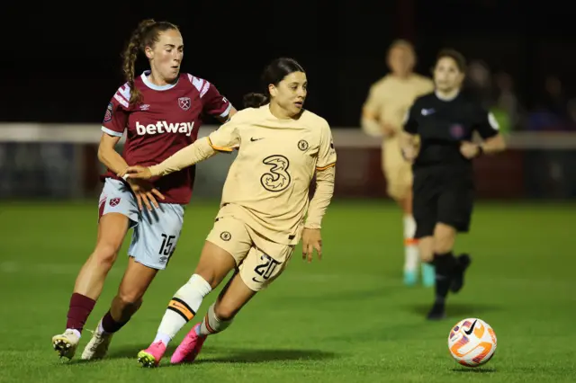 Sam Kerr of Chelsea is put under pressure by Lucy Parker of West Ham United