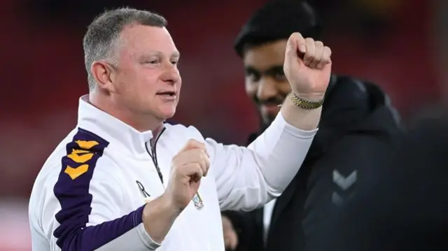 Mark Robins celebrates