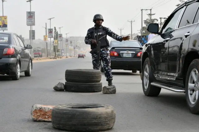 A police officer stops a car at a check point ahead of the February 25 presidential election at Awka in Anambra State, southeast Nigeria, on February 16, 2023.