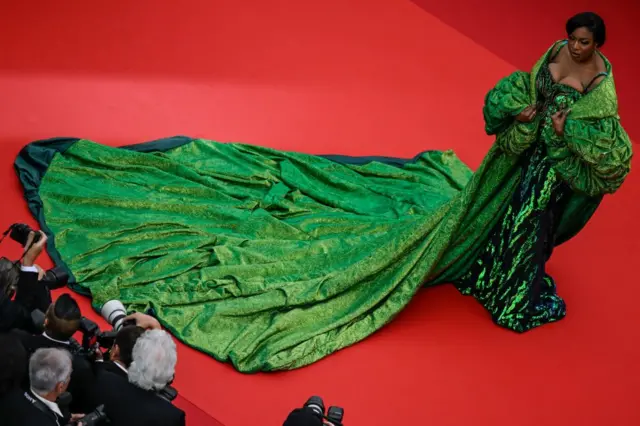 Chika Ike in a green dress on the red carpet