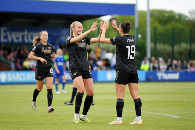 Caitlin Foord of Arsenal is congratulated by teammate Frida Maanum