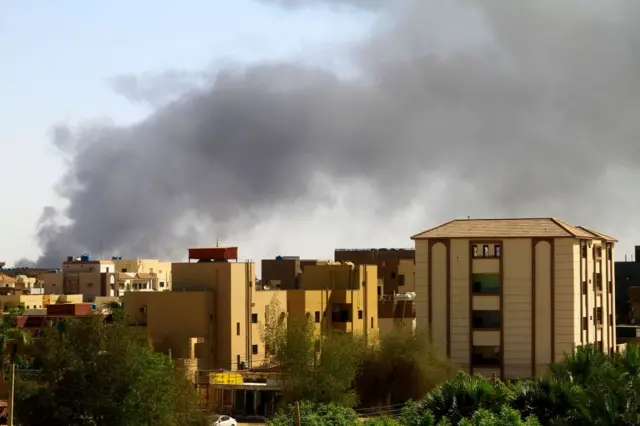 Smoke billows in the distance in Khartoum amid ongoing fighting between the forces of two rival generals, on May 15, 2023.