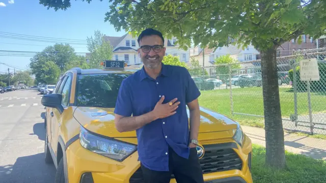 Sonny Singh poses for a picture outside his home